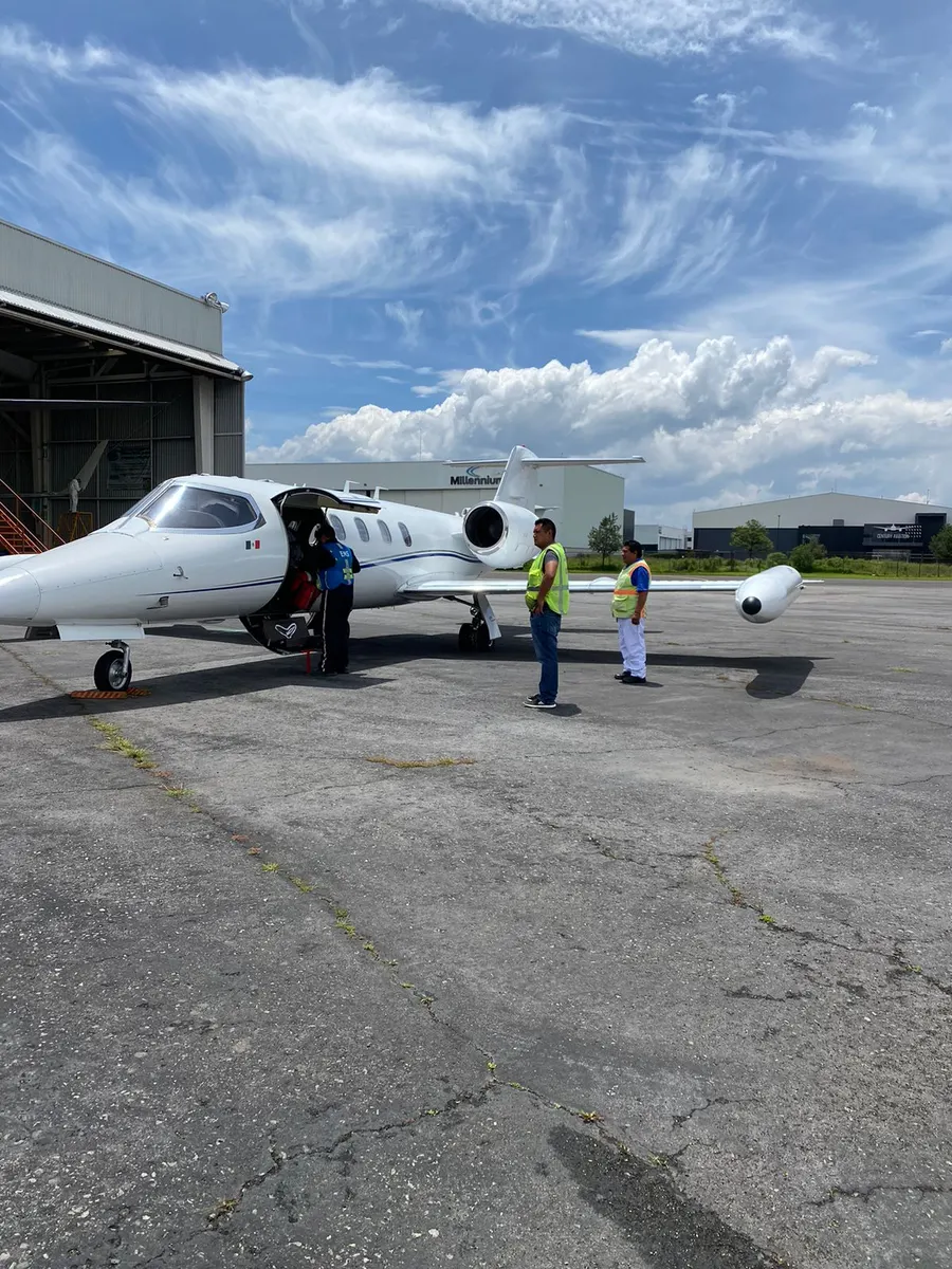 Ground crew alongside a Learjet 35